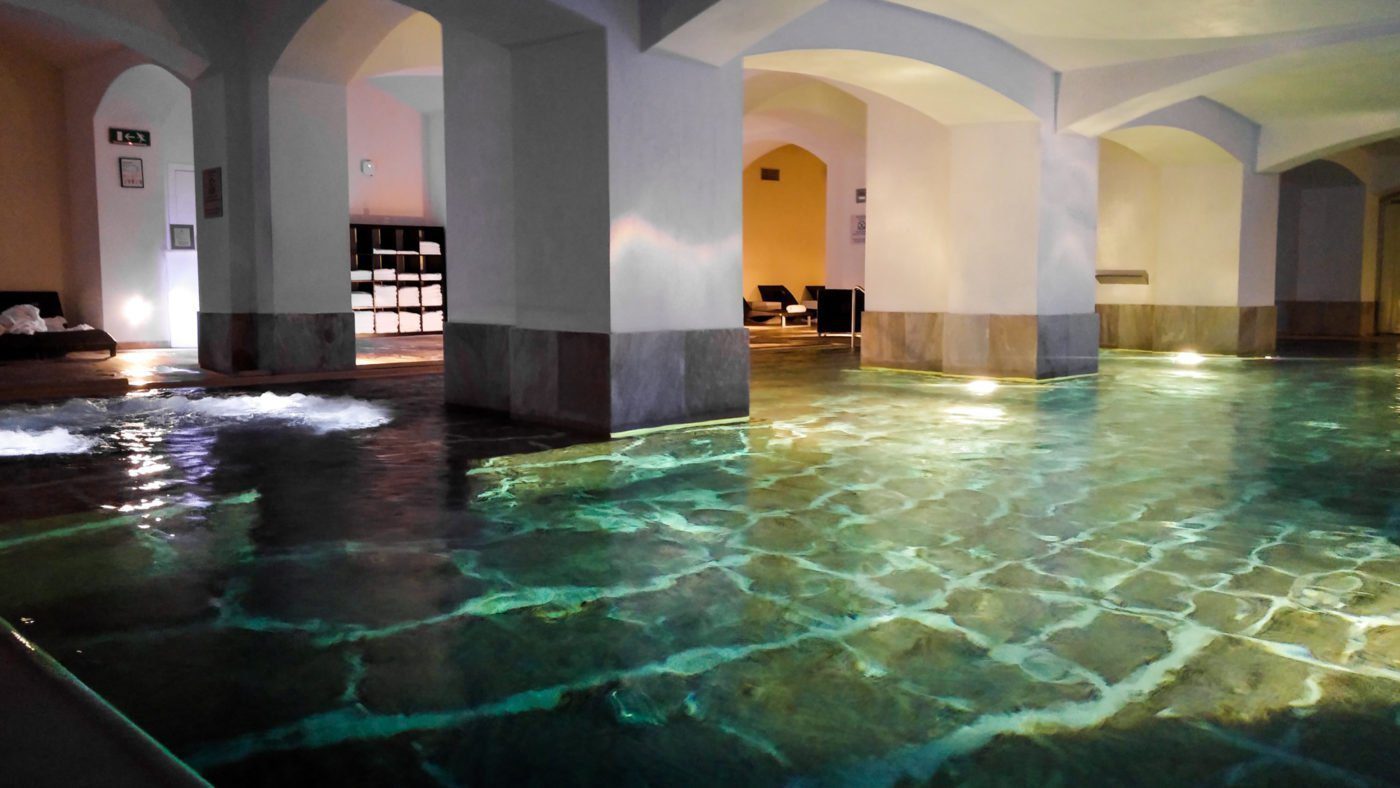 Swim between the pillars of the building in Boscolo's basement swimming pool