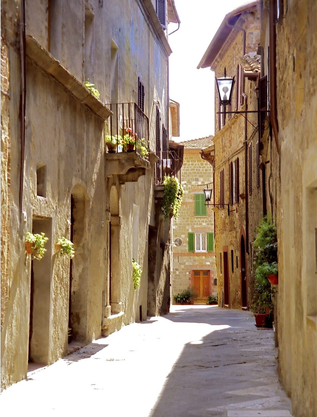 a narrow street in a village in Italy