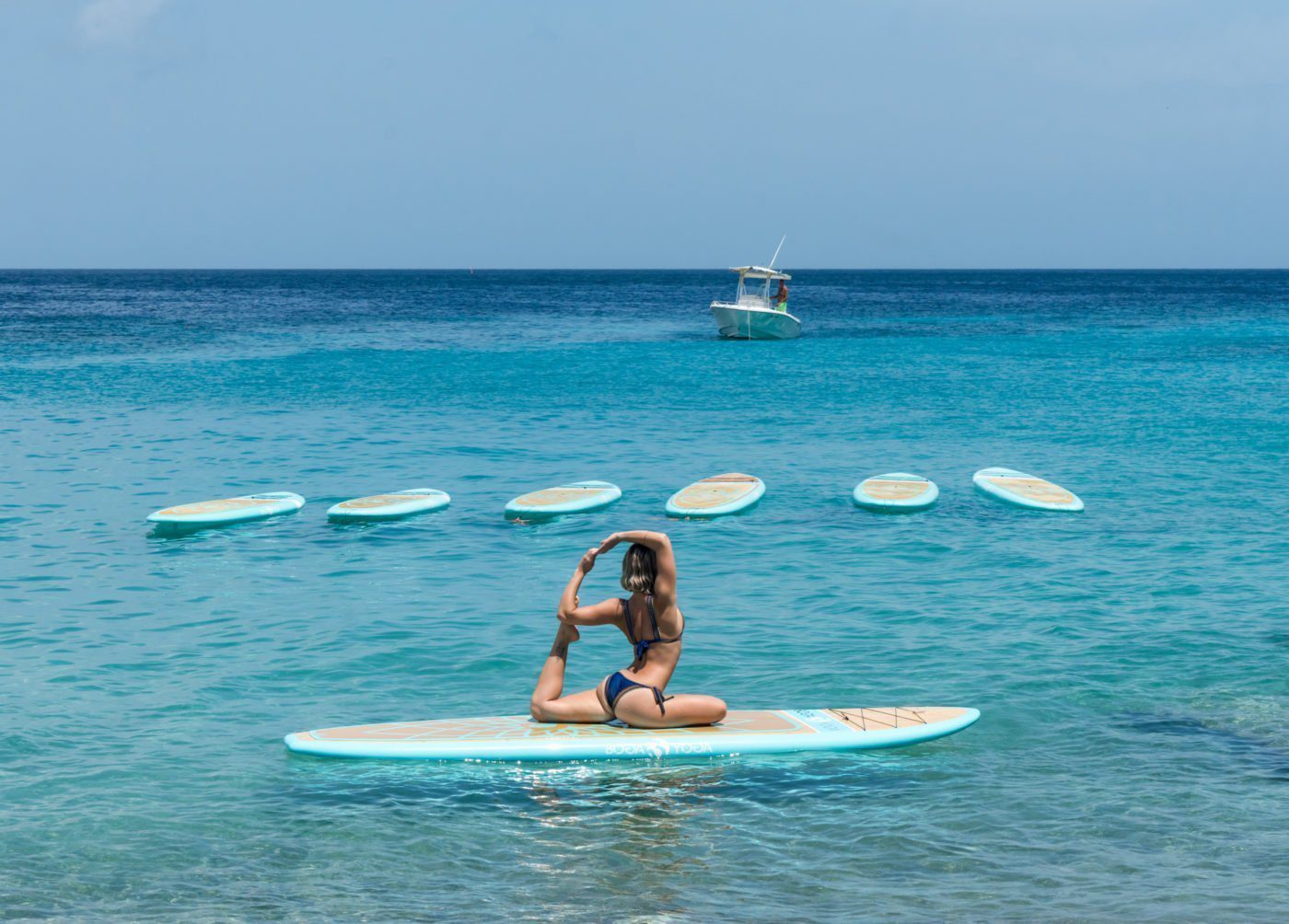 Liberty Suares from Dushi SUP doing SUP Yoga in Curaçao. Boga yoga boards